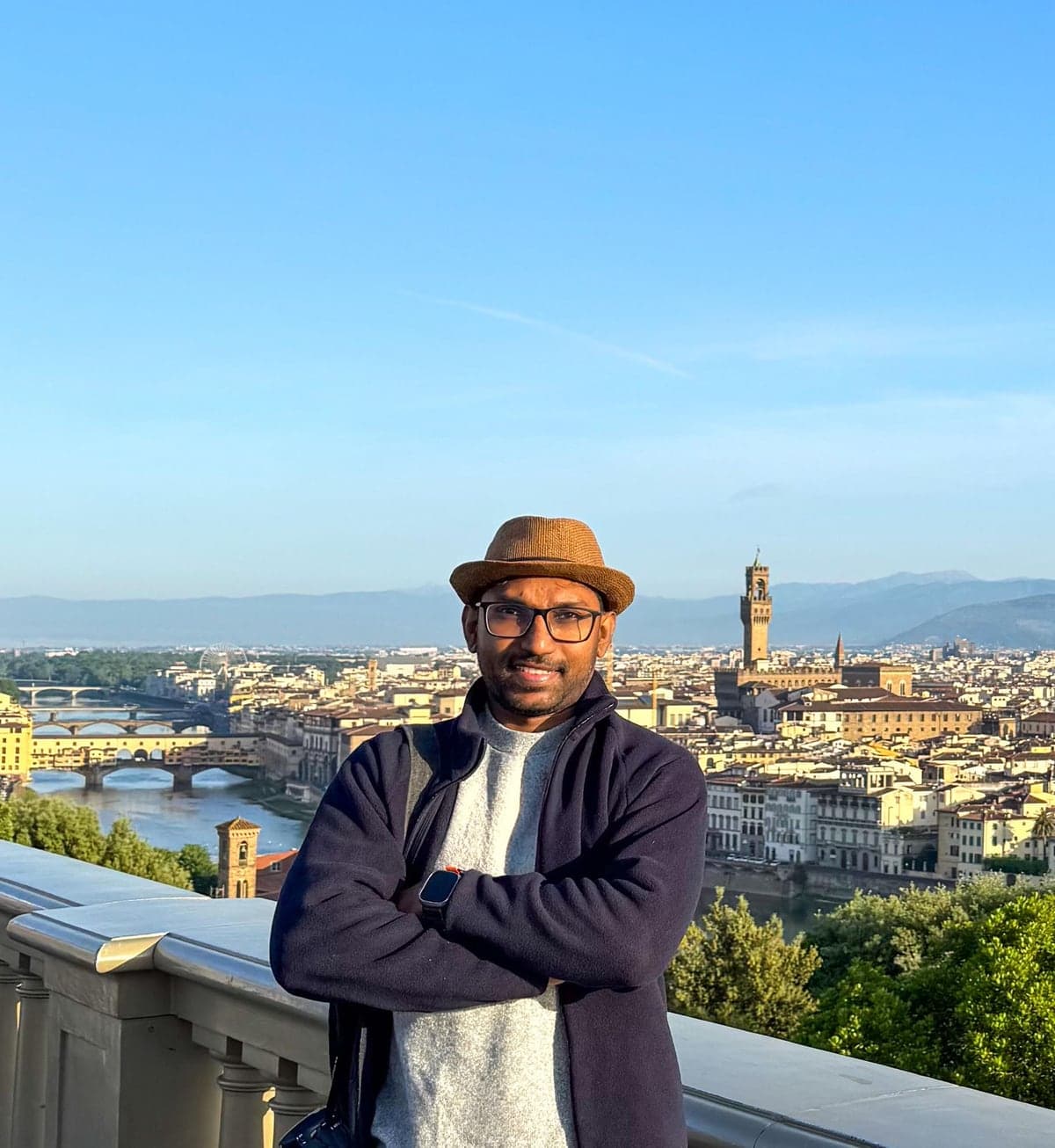 Madushan Chathuranga on a terrace above Florence, the Arno and the Palazzo Vecchio behind him.